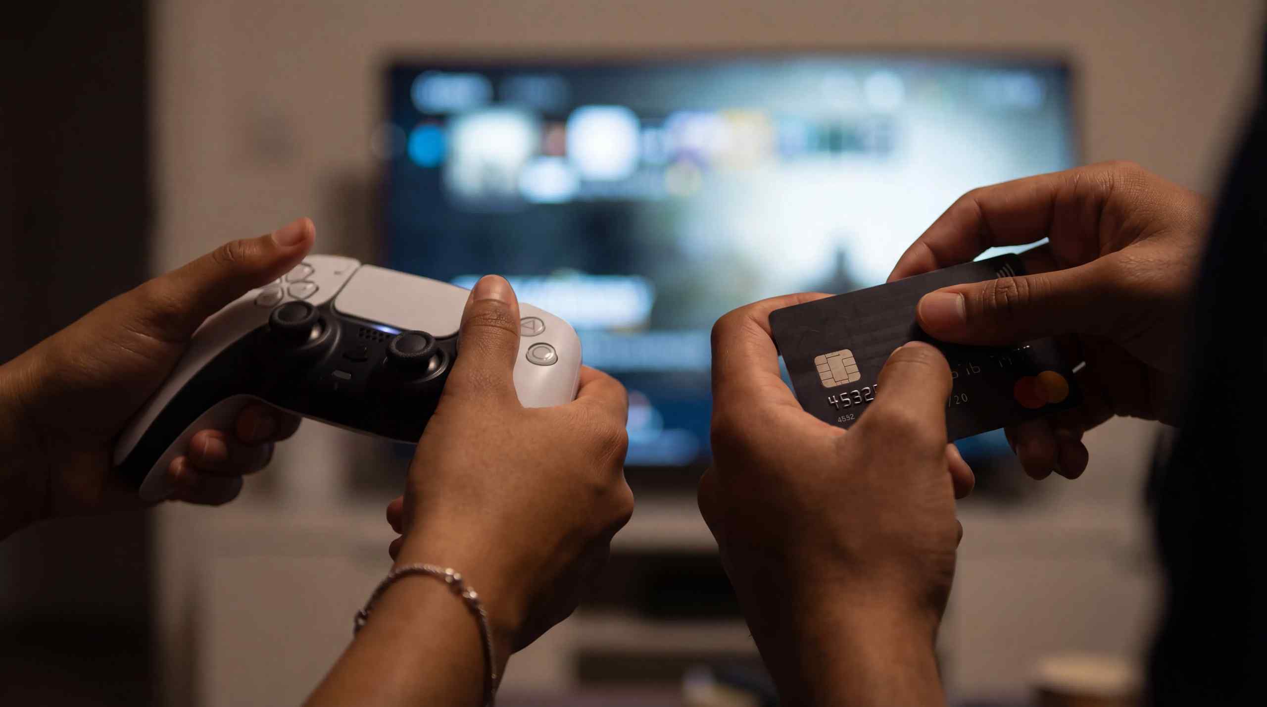 An image of someone holding a PS5 controller and another with a credit card.